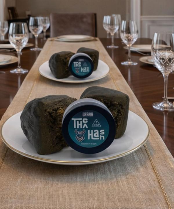 Premium Utoya 57% THCA Hash jars and concentrate portions served on white and gold saucers